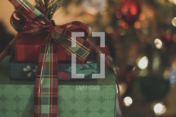 lightstock-110569-wrapped-christmas-presents-under-a-christmas-tree